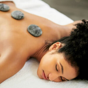 Shot of an attractive young woman getting a hot stone massage at a spa