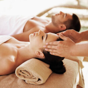 Shoot of couple having outdoor hot stone therapy