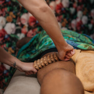 Professional salon deep tissue massage treatment for a relaxed handsome black man during a pampering moment