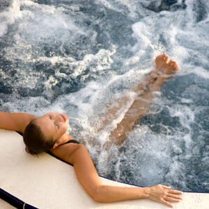 woman relaxing in an outdoor hot tub