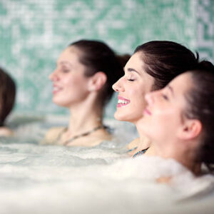friends relaxing in hot tub at health spa