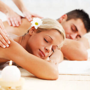Young couple is having a back massage at the spa centre.