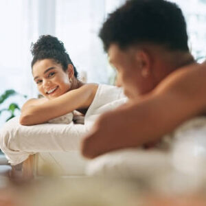 Couple, smile and bed at spa for wellness with massage session, anniversary date and hospitality service. People, rest and talking for holistic peace, healing treatment and bonding together at resort