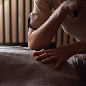 Professional massage therapist is working on client back, providing deep tissue therapy for relaxation and muscle pain relief.