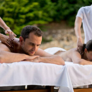 Romantic couple getting a massage at the spa and looking very relaxed - wellness concepts