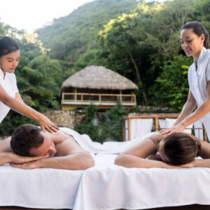 Romantic couple relaxing at the spa and getting a back massage â relationship concepts