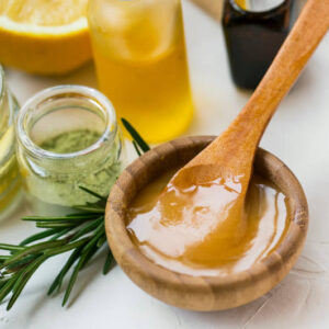 Organic skincare ingredients with manuka honey, oils, clay and rosemary herb, spa still life products honey closeup